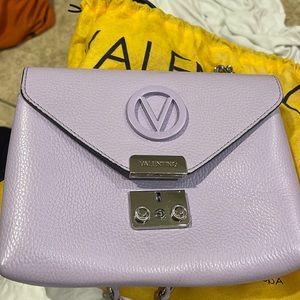 Lavender purple medium size bag lightly used, has a few scratches on the metal..